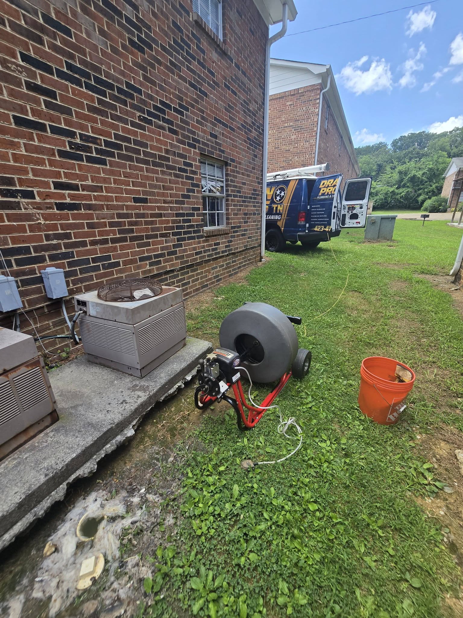 Running a drain machine at an outdoor cleanout
