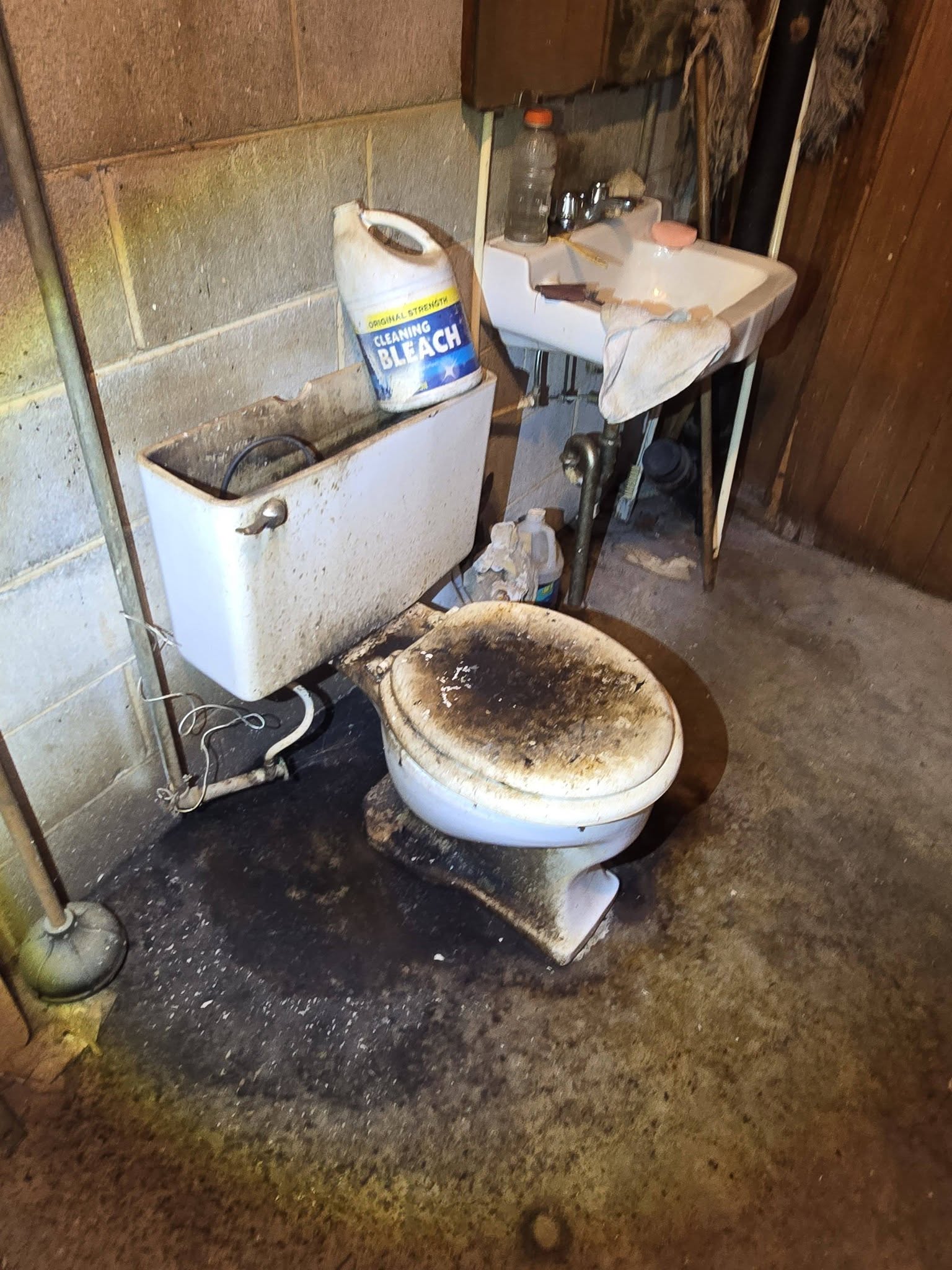 Toilet pulled and the flange exposed, before the repair