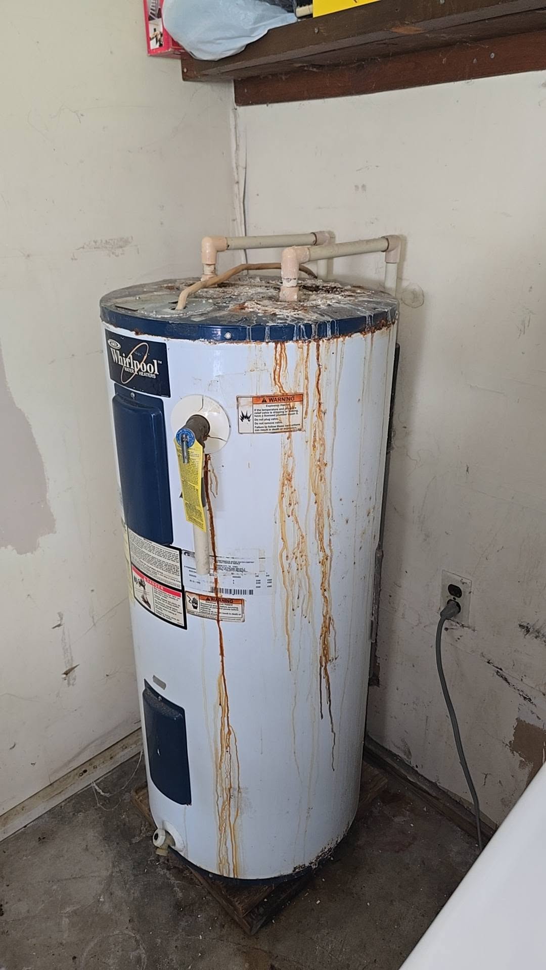 The old water heater in place before replacement